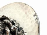 a silver ring that has a chain on it