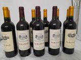 six bottles of wine are lined up on a table