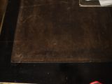 a brown piece of leather on a black table