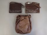 a brown purse and a brown purse on a table