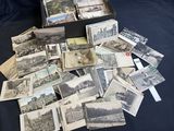 a black box full of old postcards on a table
