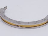 an image of a close up of a metal bracelet on a white surface