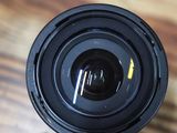 a close up view of a camera lens on a wooden table