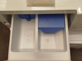 a drawer that has two blue bins inside of it