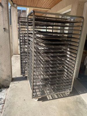 an image of a metal rack with trays of food