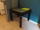 a small table with a yellow plate on it