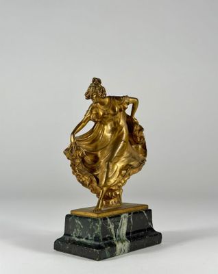 a gold statue of a woman holding a basket on a marble base