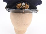 navy officer ' s visor hat with eagle emblem on top