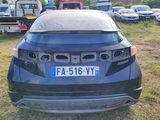 a car that is parked in the grass near other cars