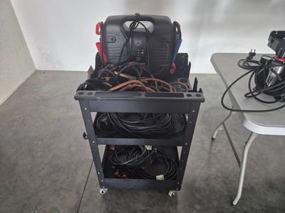 a small cart with a lot of wires on it