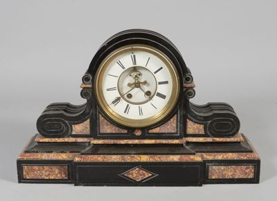 a black and gold clock on a stand with roman numerals