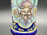a blue vase with a picture of a man on it