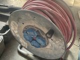 a hose that is sitting on a cart in a garage