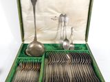 silverware in a green box on a white surface