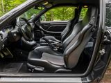the interior of a car with the door open and the seats down