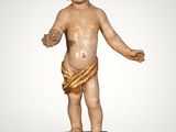 an image of a statue of a child with a bow around his waist