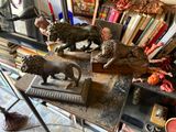 some statues of lions on a table in a room