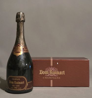 a bottle of champagne sitting next to a box