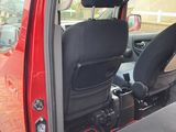 a red car with black seats and a black seat belt