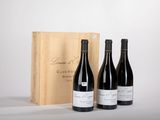trois bouteilles de vin devant une caisse en bois