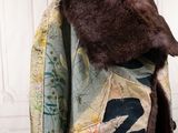 a coat with a fur collar on a mannequin