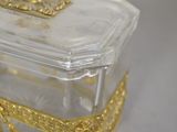 a glass box with a gold decoration on it