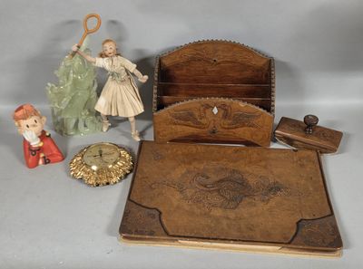 a small wooden box with a doll and other items on it