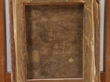 an old wooden easel with a picture frame on top of it