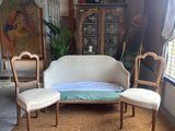 a couch and two chairs in a room with a rug