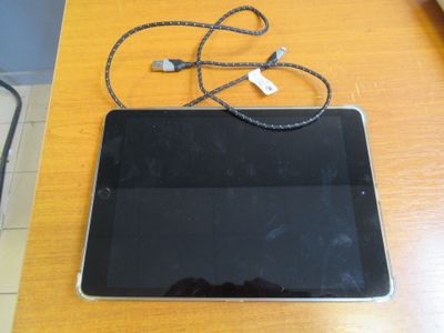 a tablet computer sitting on top of a wooden table