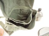 a bag that is sitting on a table next to a bottle