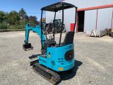 a blue mini excavator parked in front of a building