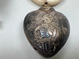 a silver locke with a picture of a woman on it