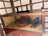 a wooden shelf with a chair and other items on it