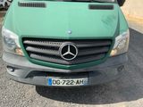 a green van that is parked in a parking lot