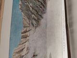 an open book with a picture of a mountain in it