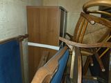 an image of a cluttered room with a chair and other furniture