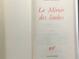 an open book with red writing on it sitting on a table