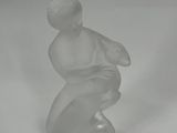 an image of a glass figurine of a boy on a skateboard