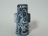 an image of a black and white vase with writing on it