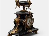 a black and gold clock sitting on top of a table