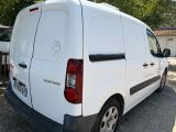 a white van that is parked on the side of the road