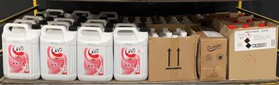 a truck with several containers of liquid on the back of it