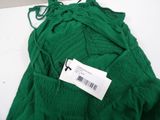 green pants with a price tag on them sitting on a table