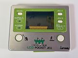 a silver and green electronic device on a white surface