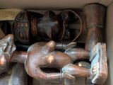 a box filled with wooden sculptures and other items