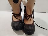 pair of black and white boots with fur linings on them