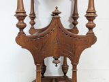 a clock that is on the back of a wooden chair