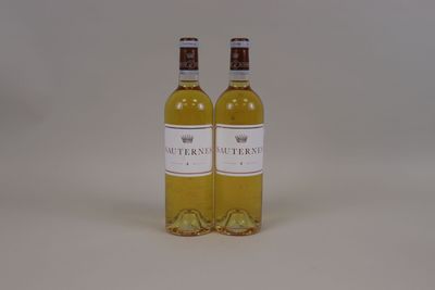 two bottles of white wine sitting next to each other on a table