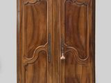 an old wooden cabinet with two doors and a drawer on top of it